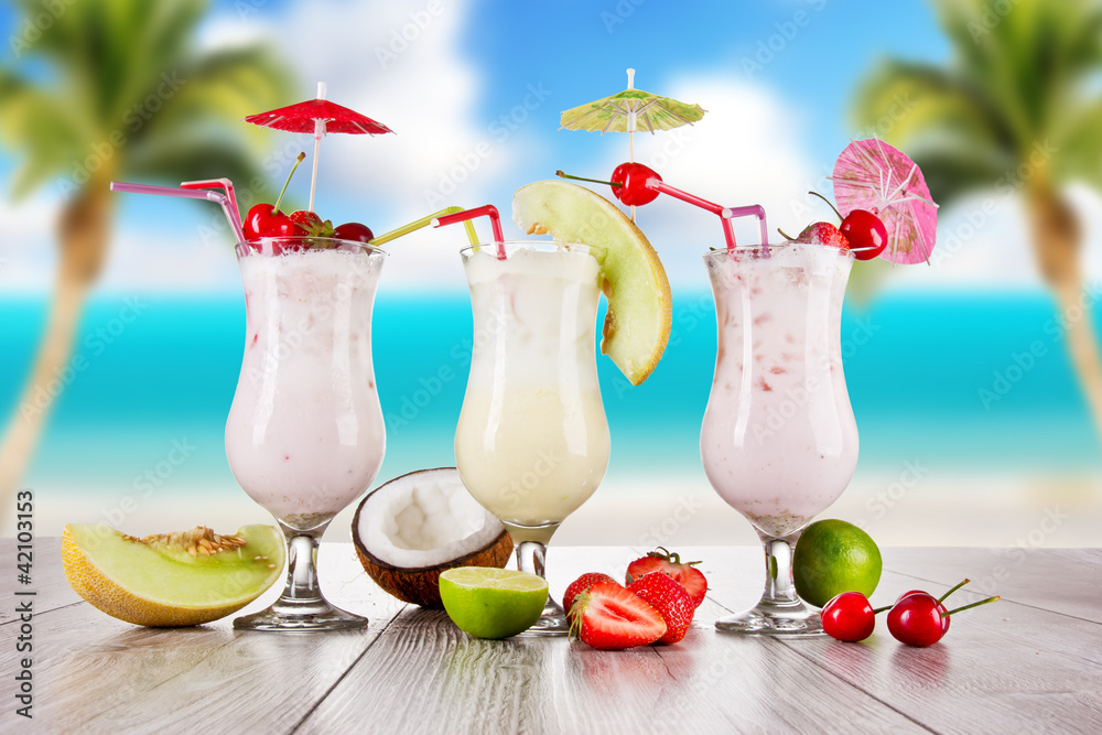 Pina colada drinks with blur beach on background - obrazy, fototapety, plakaty 
