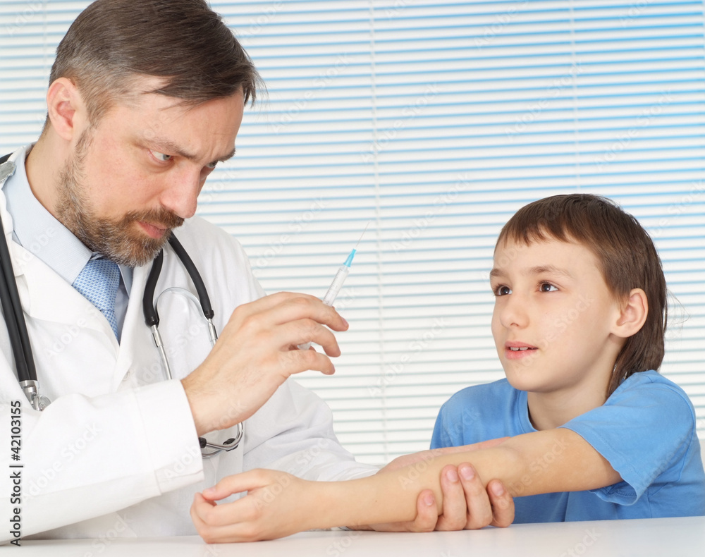A beautiful adult Caucasian doctor with a boy sitting A beautiful adult Caucasian doctor with a boy sitting