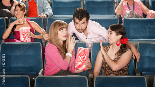 Men and Women Flirting in Theater photo