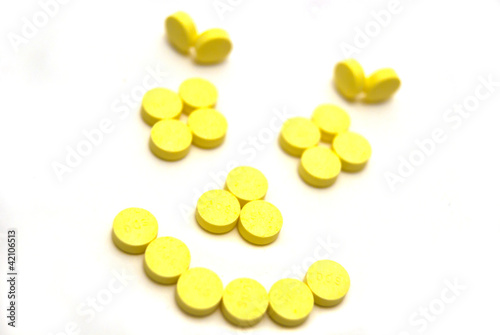 Yellow tablets on white