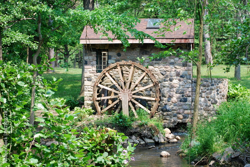 A Rustic Waterwheel with Foliage A Rustic Waterwheel with Foliage