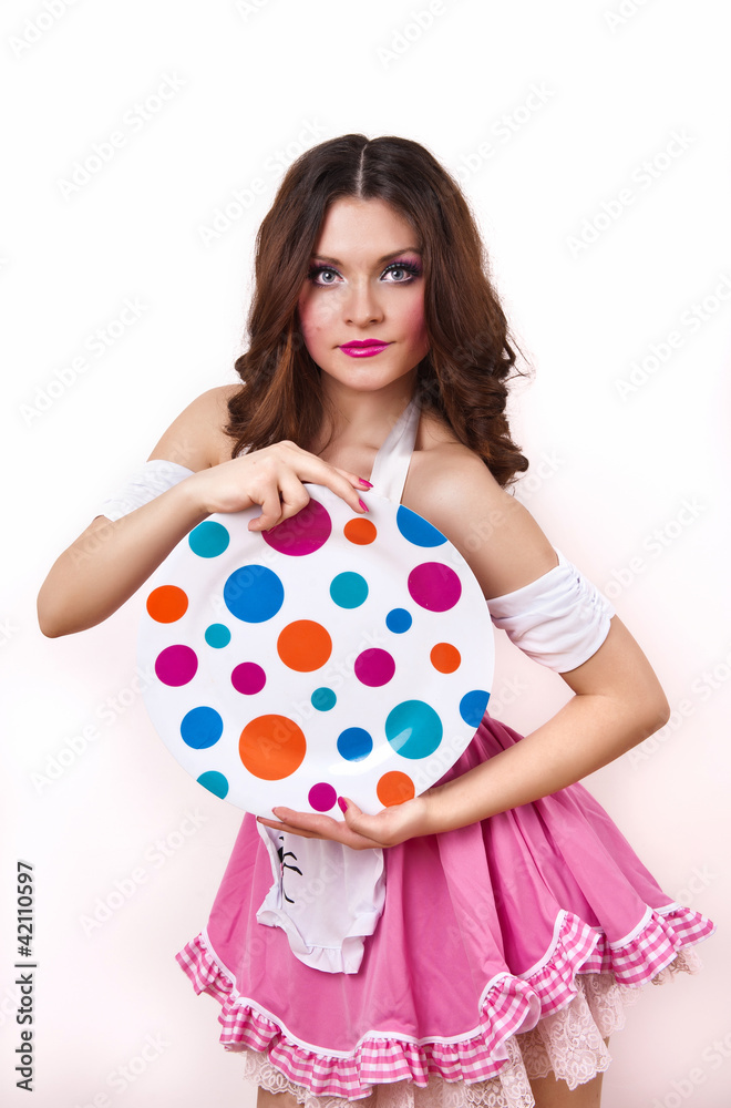Pretty woman with pink dress and colored plate. Looking forward Pretty woman with pink dress and colored plate. Looking forward