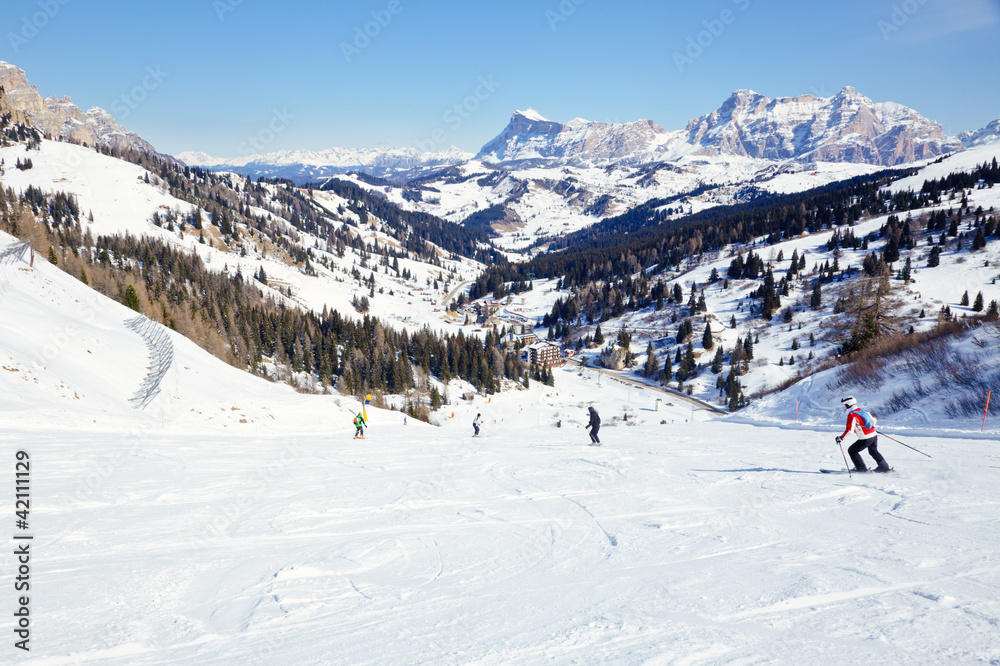 Skiers on a piste