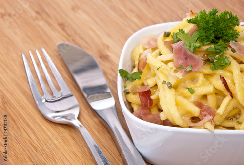 Bowl with Cheese Spaetzle and cutlery photo