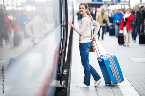 Pretty young woman boarding a train
