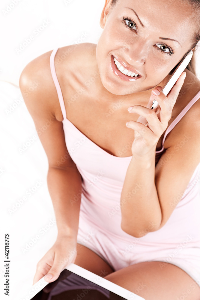 young beautiful woman talking on the phone , tablet pc young beautiful woman talking on the phone , tablet pc