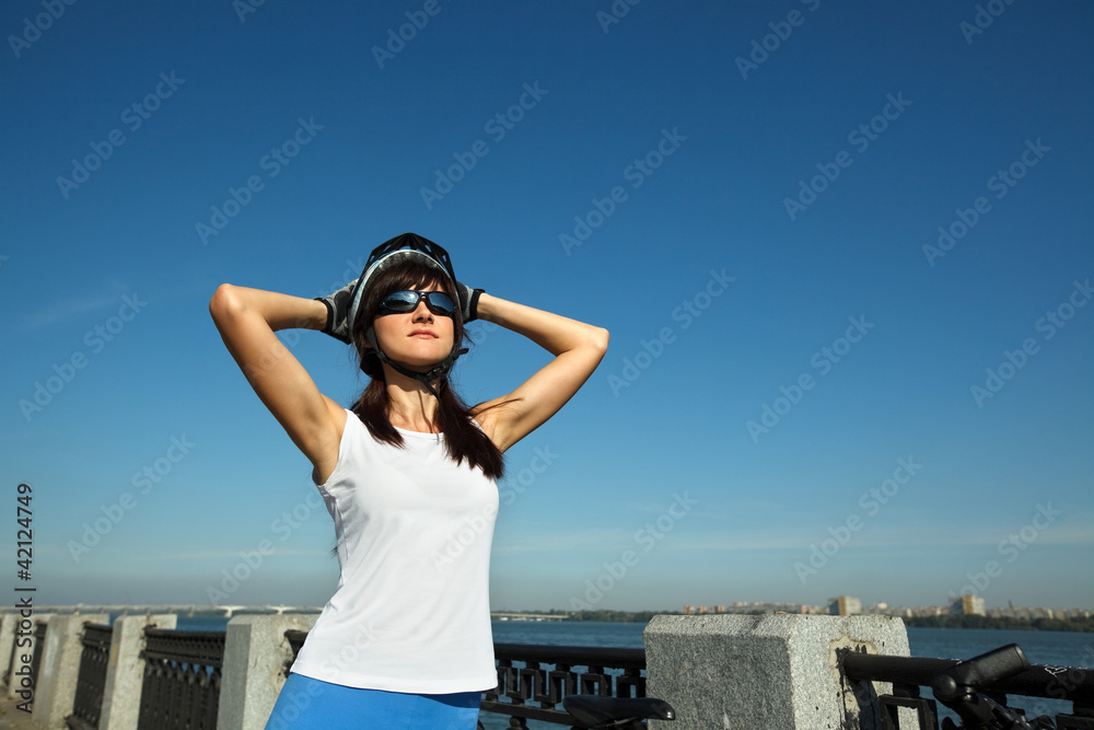 Female cyclist enjoying fresh air with hands behind head Female cyclist enjoying fresh air with hands behind head