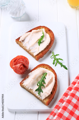 Crispy bread with spread and salami