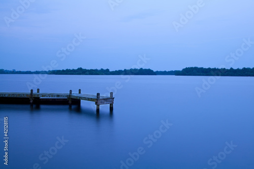 wooden pier on the lake at night