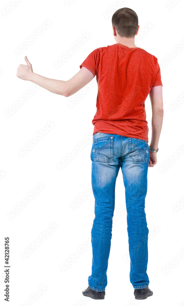 Back view of young men in orange t-shirt going thumb up. Back view of young men in orange t-shirt going thumb up.