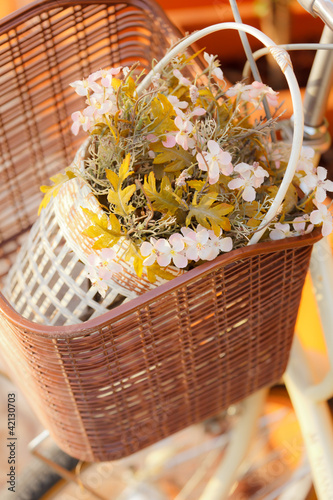 Photos Artificial flower in bicycle basket