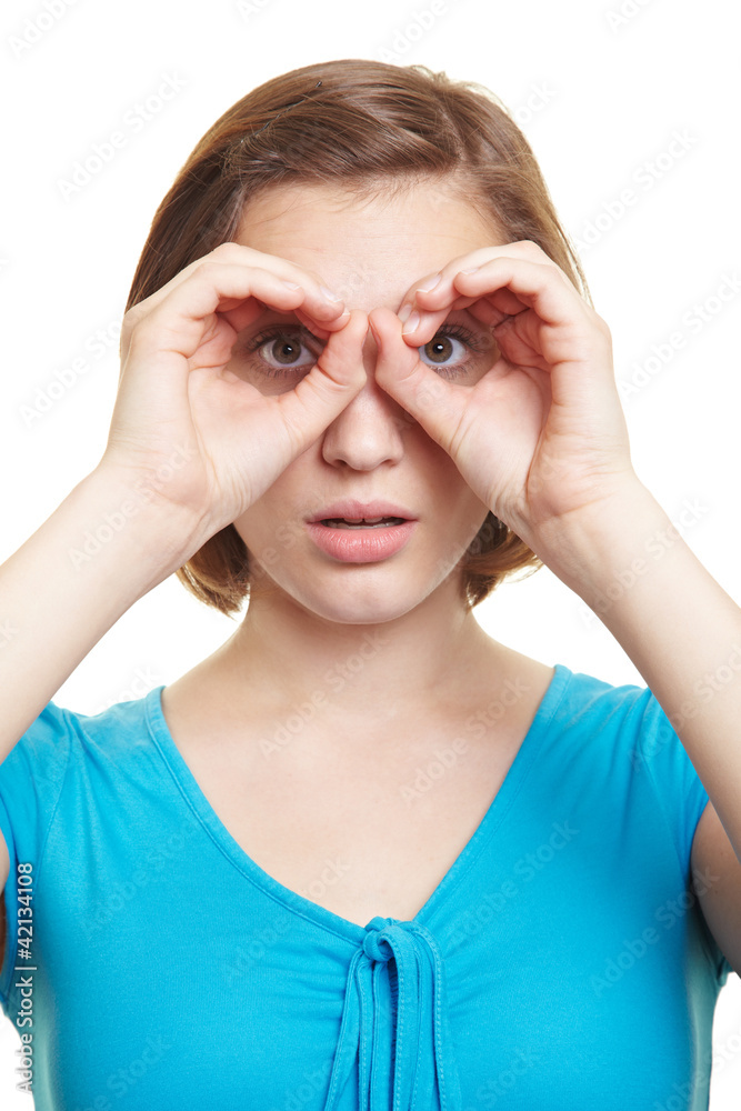 Frau schaut durch ihre Finger Stock Photo Adobe Stock