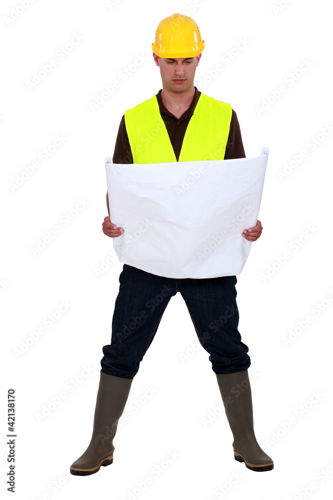 A foreman checking the plans. A foreman checking the plans.