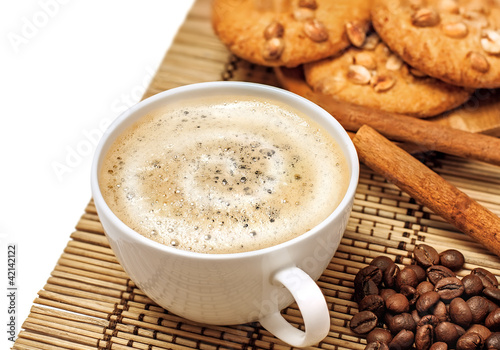 Coffee cup with cookies and cinnamon, isolated on white