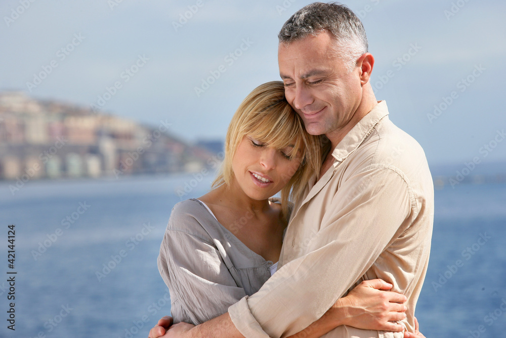 Couple hugging by the sea