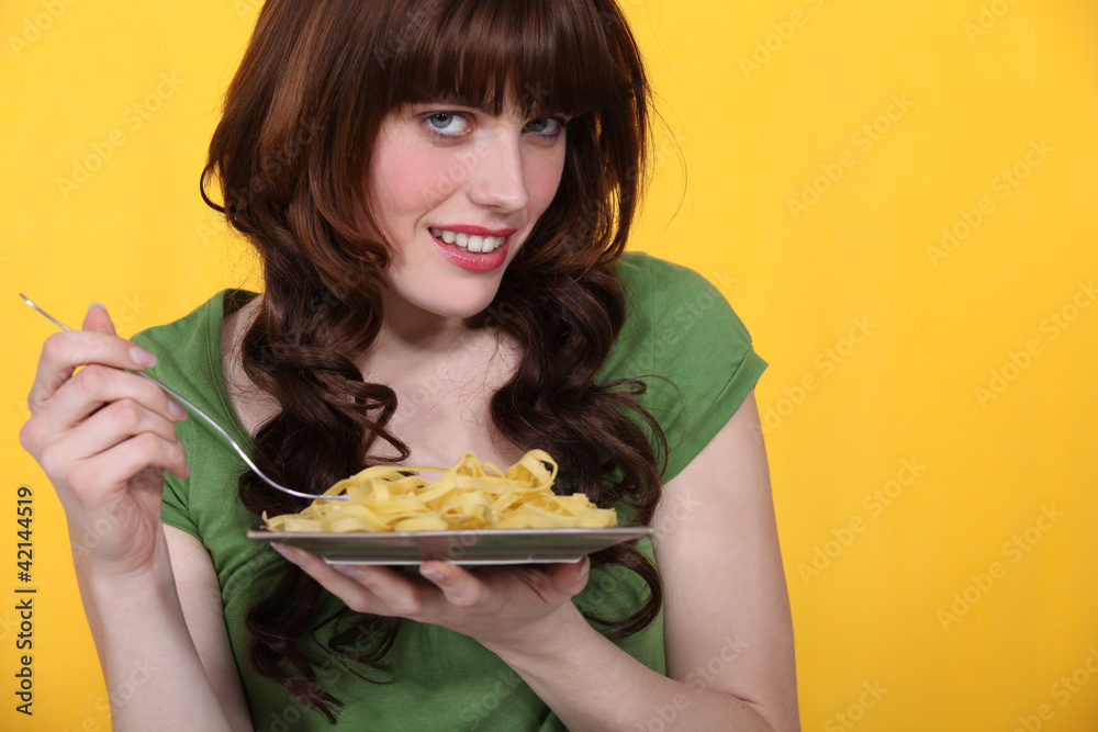 Woman eating pasta