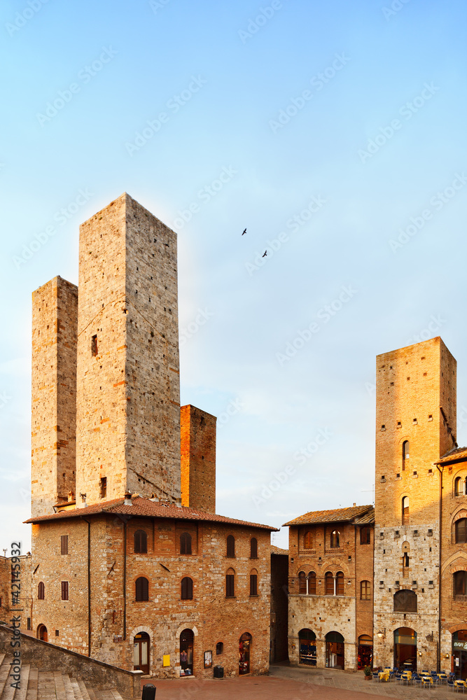 San Gimignano sunset, towers in central square. Tuscany Italy