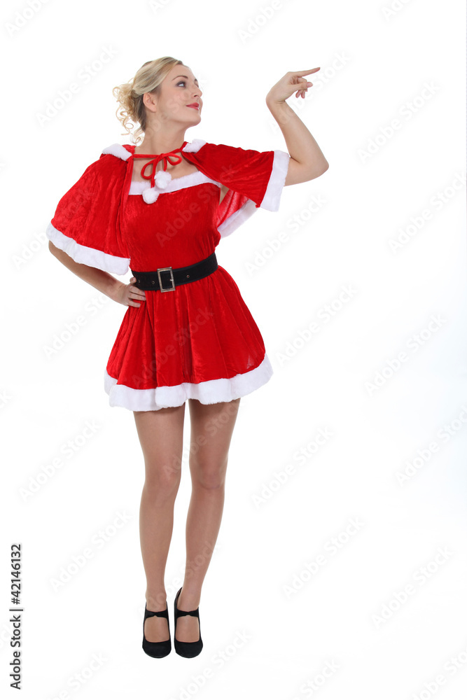 gorgeous blonde in christmas outfit pointing to her side gorgeous blonde in christmas outfit pointing to her side