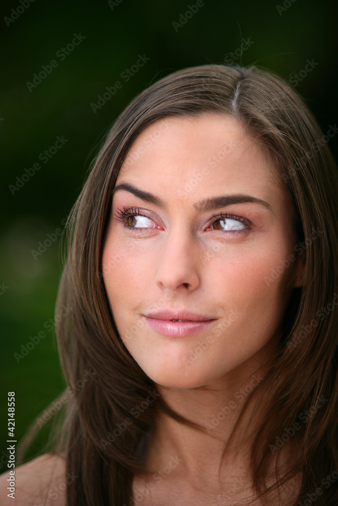 Head-shot of brunette stood outdoors Head-shot of brunette stood outdoors