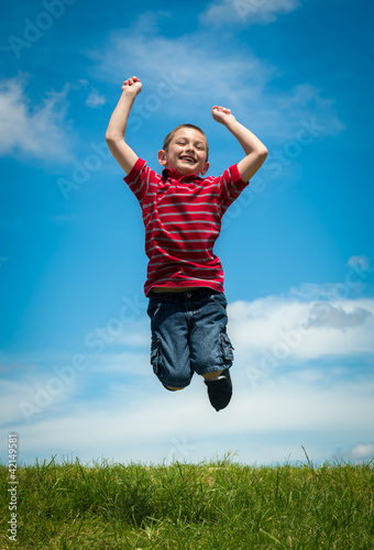Joyful kid jumping happy