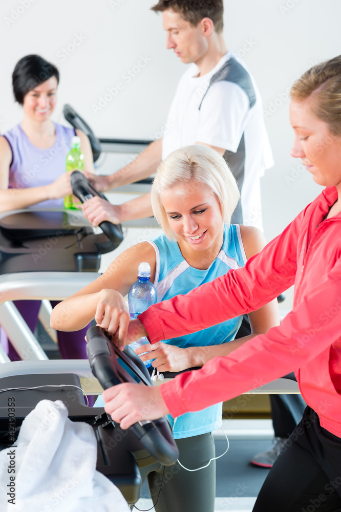 Young woman on fitness treadmill give instructions