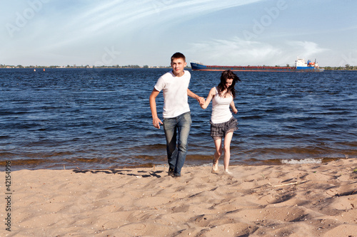 Loving couple running on beach