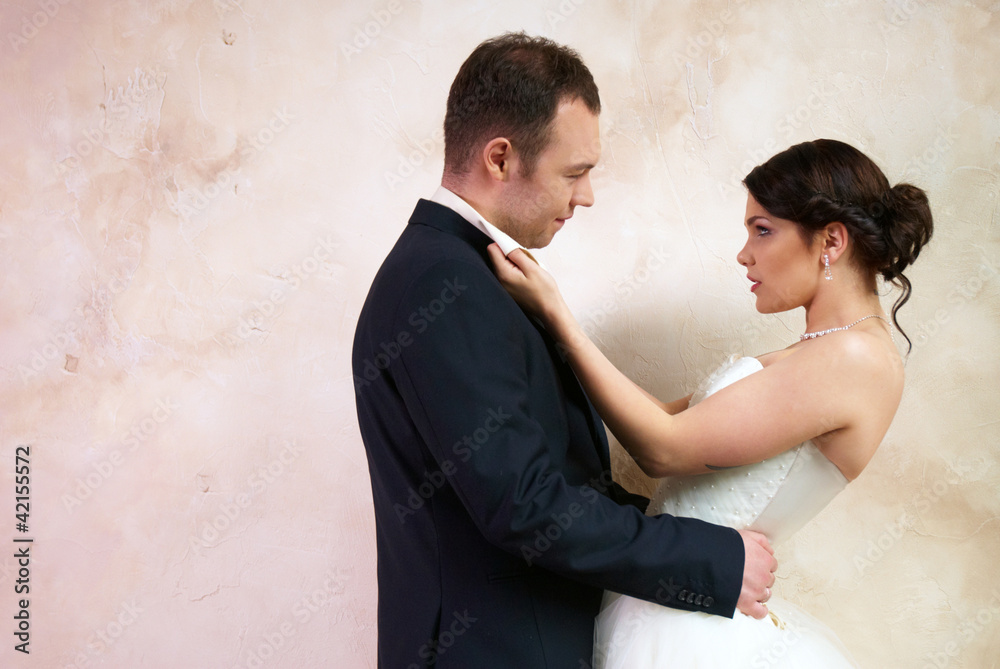 bride and groom hugging in empty room bride and groom hugging in empty room