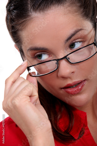 Woman seductively removing glasses photo