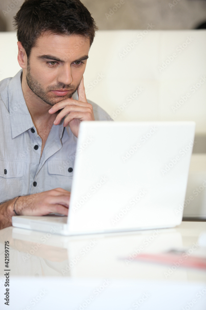 Man using laptop at home