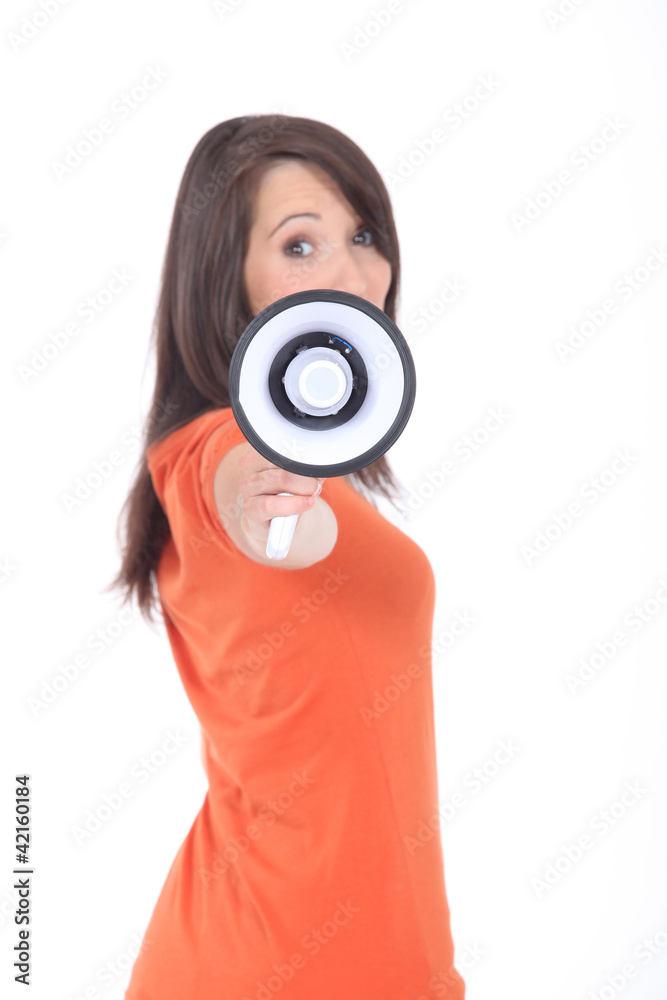 Fototapeta premium Profile view of young woman holding megaphone