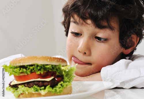 Boy on temptation with burger