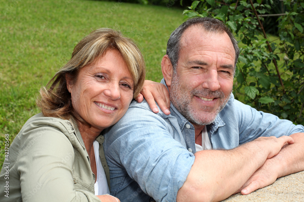 Portrait of senior couple relaxing in garden Portrait of senior couple relaxing in garden