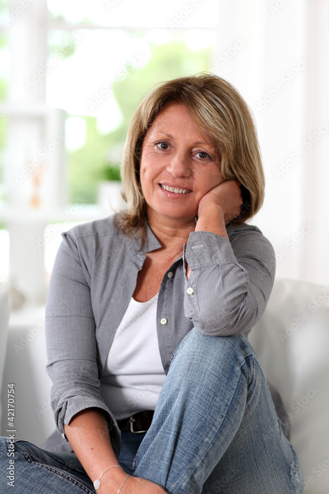 Senior woman at home sitting in sofa Senior woman at home sitting in sofa