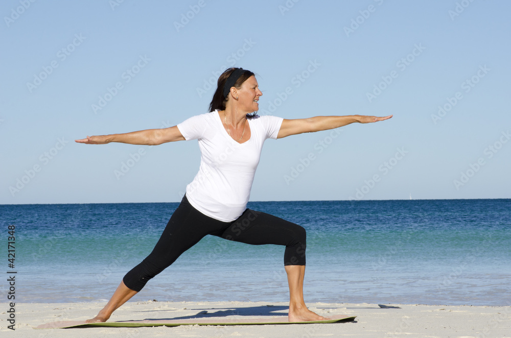 Mature woman exercising at beach Mature woman exercising at beach