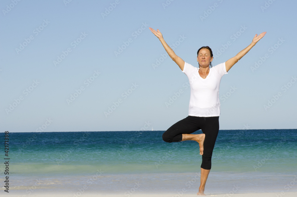 Mature woman exercising at beach Mature woman exercising at beach
