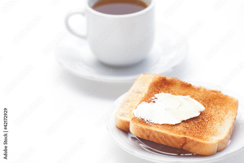 tea and toast with butter isolated on white tea and toast with butter isolated on white