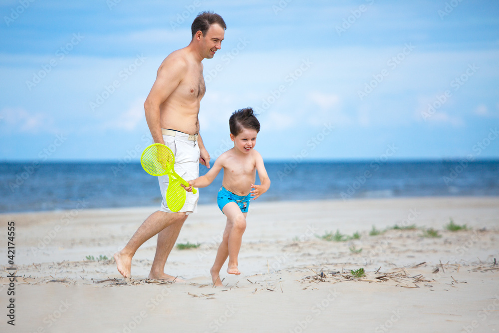 Happy father and son on the beach. Happy father and son on the beach.