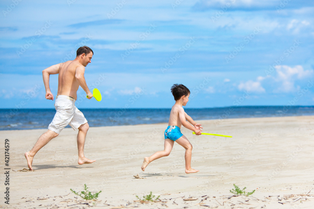 Father and son playing on the beach