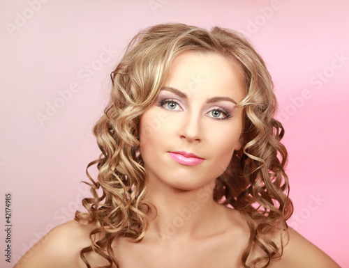 Closeup portrait of a beautiful woman, isolated on pink