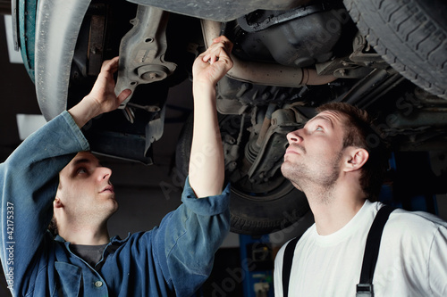 Two Car Mechanic repairing car © baranq