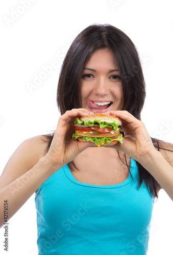 woman with tasty fast food unhealthy burger in hand hungry