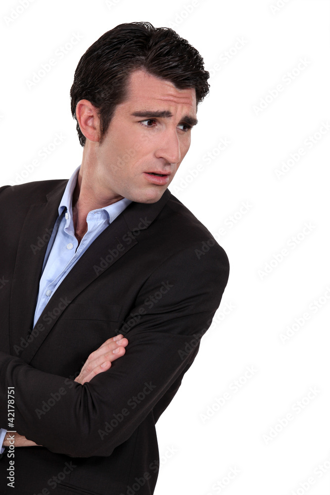 Businessman with his arms folded in disbelief Businessman with his arms folded in disbelief