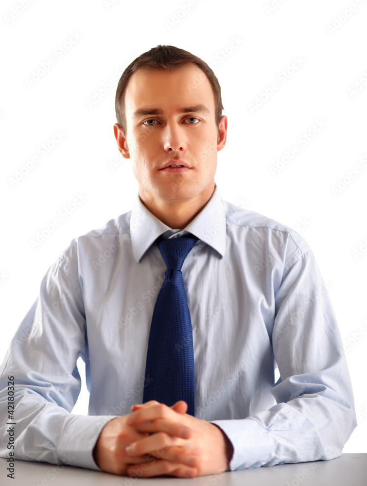 The businessman sitting on the desk in office The businessman sitting on the desk in office
