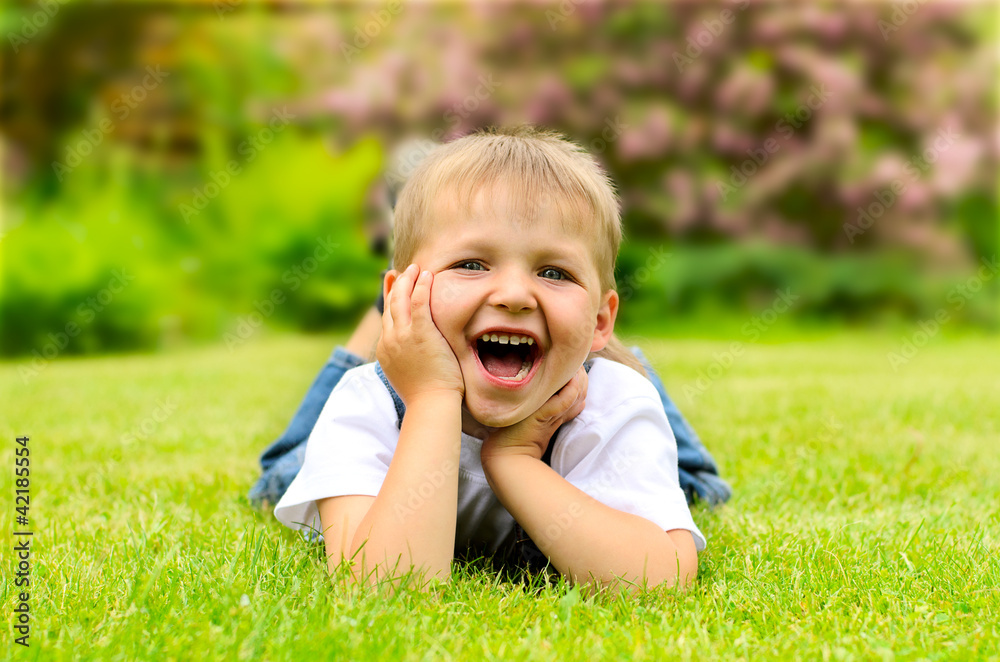 Little boy lying on a green grass Little boy lying on a green grass