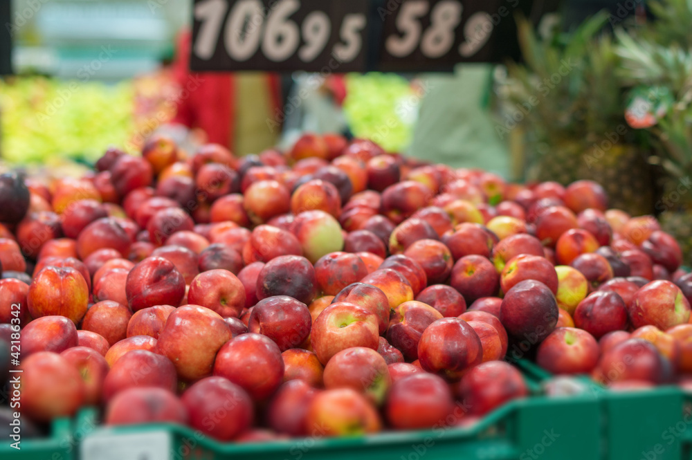 Variety of nectarines in boxes in supermarket Variety of nectarines in boxes in supermarket
