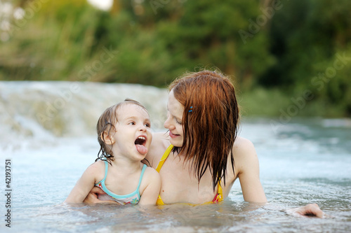 Adorable girl and her mom on a beach