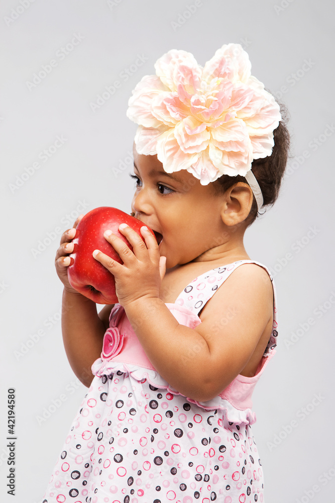 Lovely little girl biting an apple Lovely little girl biting an apple