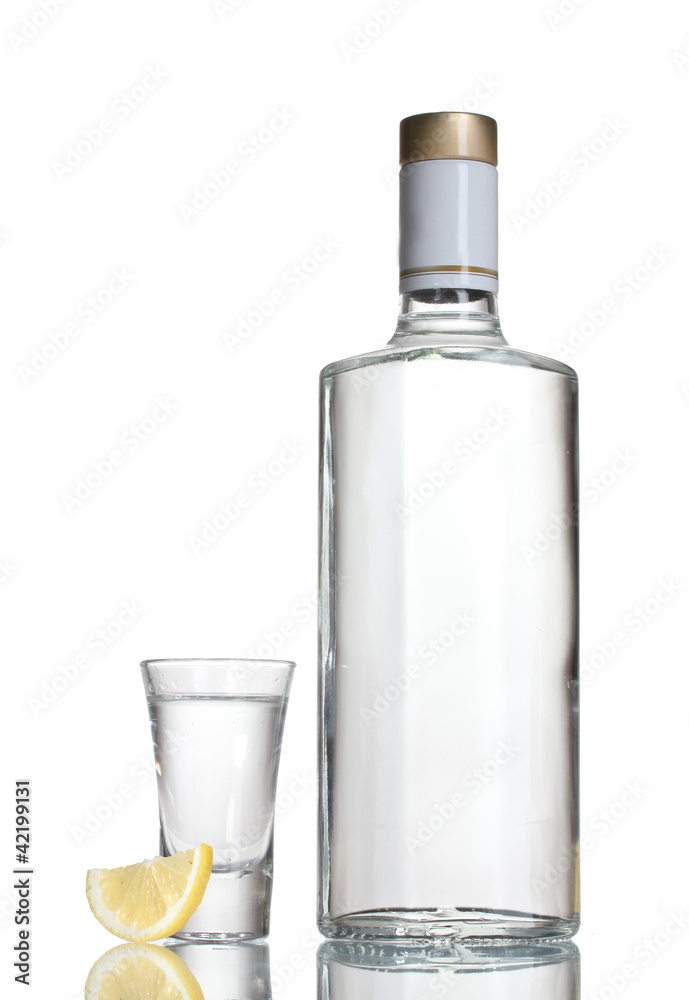 Bottle of vodka and wineglass with lemon isolated on white Bottle of vodka and wineglass with lemon isolated on white