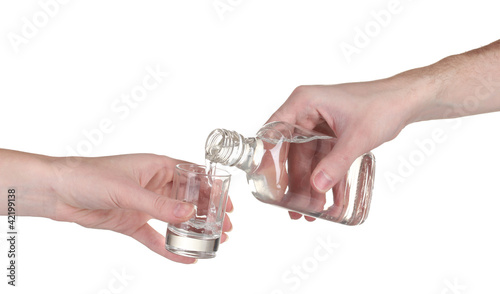 Vodka poured into a glass isolated on white