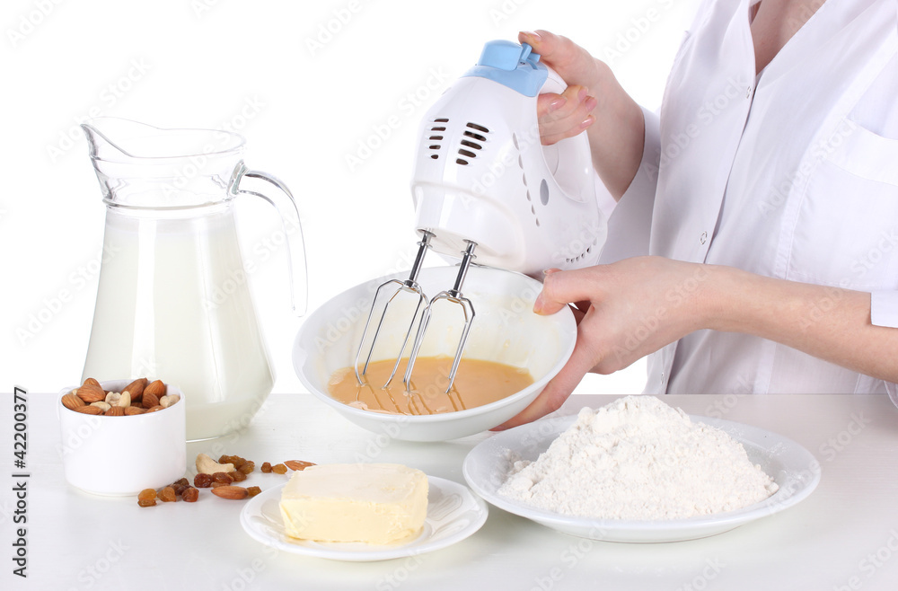 Female hands mixing eggs in bowl isolated on white Female hands mixing eggs in bowl isolated on white